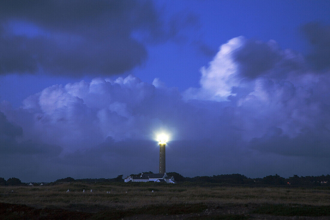 Brittany, Belle-Ile: large lighthouse  under the cloudy sky
