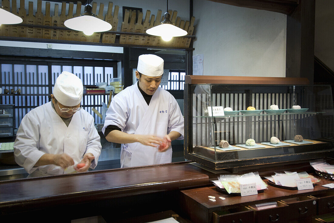 Japan, Kyoto, two masters preparing pastry  Wagashi, types of colourful Japanese sweets