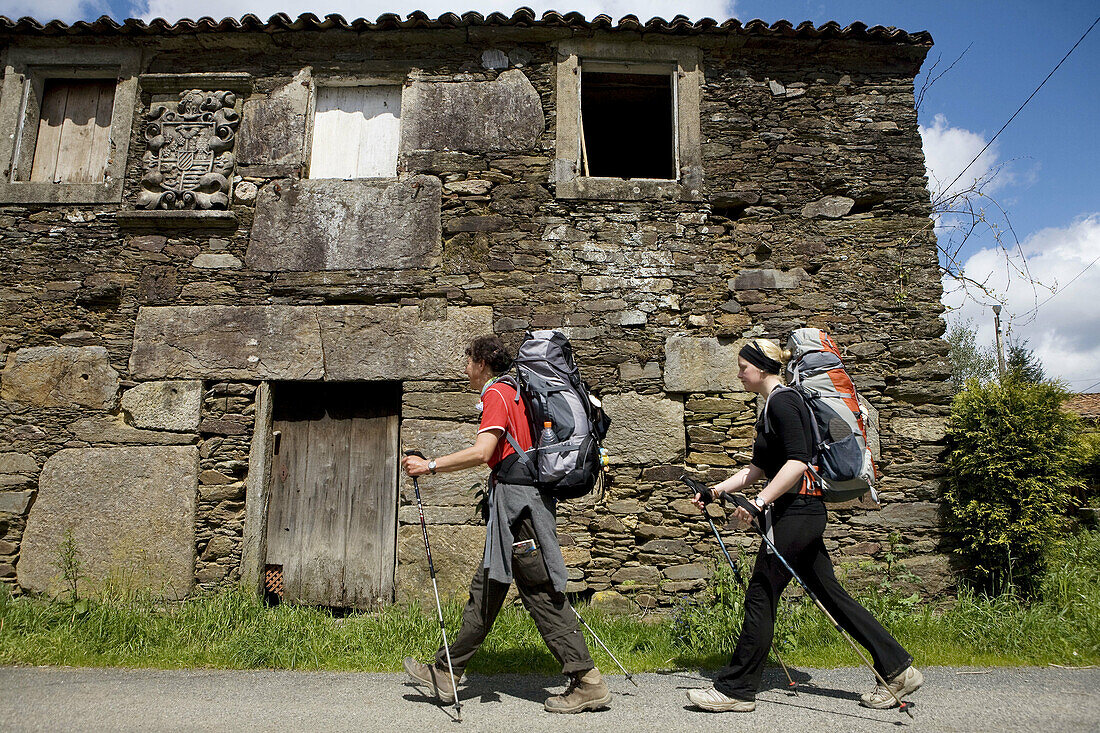 Pilgrims on the St. James Way near Santiago de Compostela. La Coruña province, Galicia, Spain