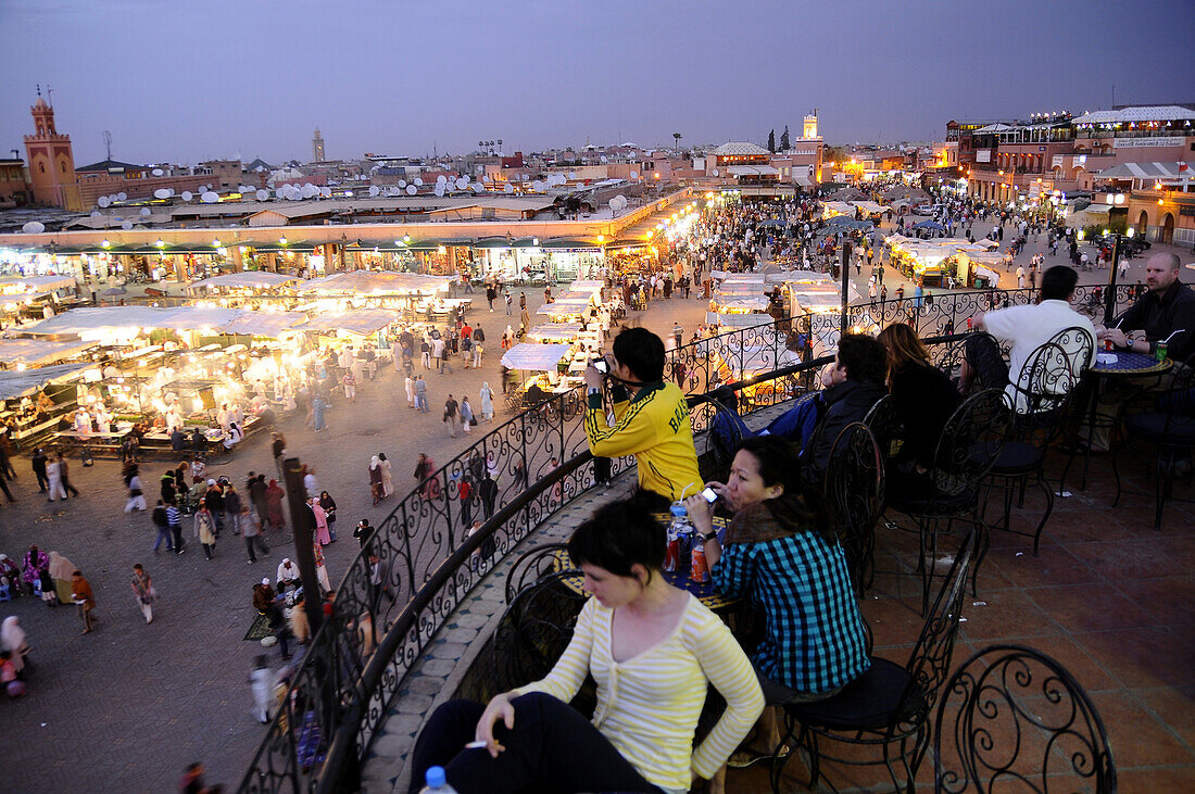 People at a cafe over Place Jemaa el-Fna in the evening, Marrakesh, South Morocco, Morocco, Africa