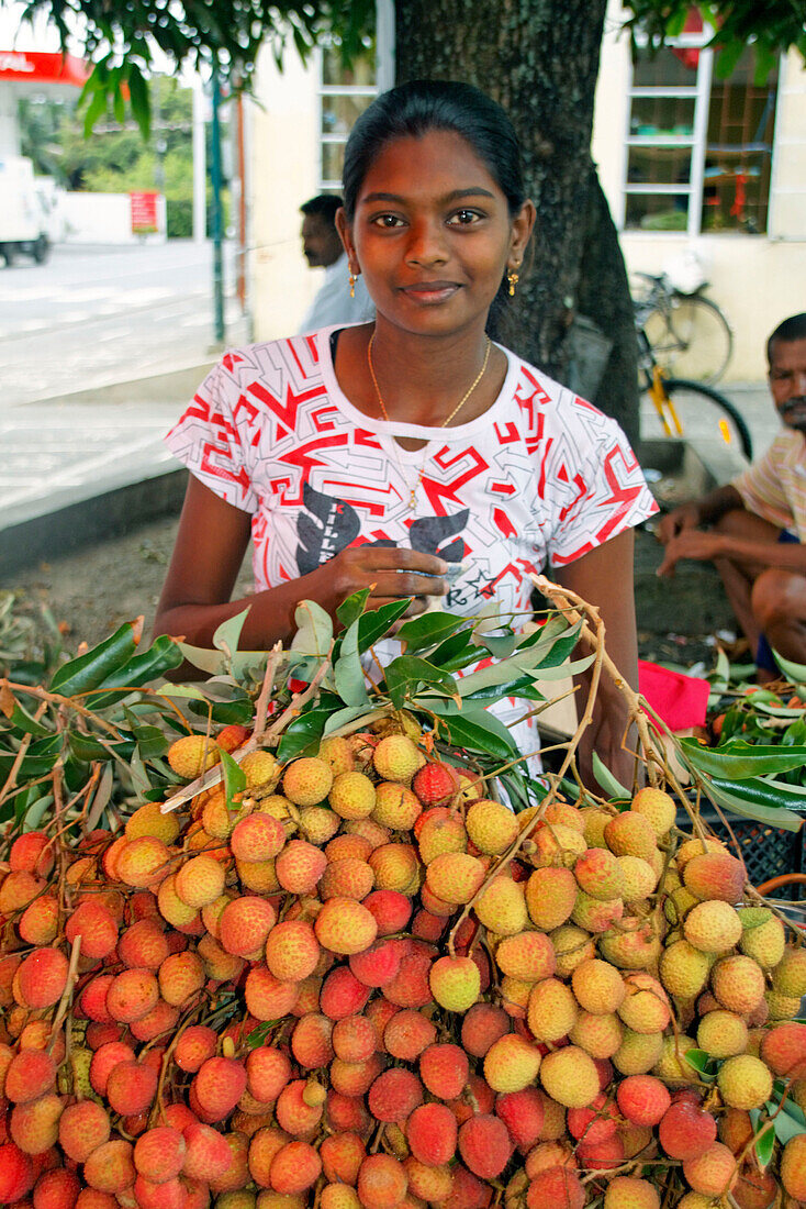 Indian Girl with Lischis friut stall, Mauritius, Africa
