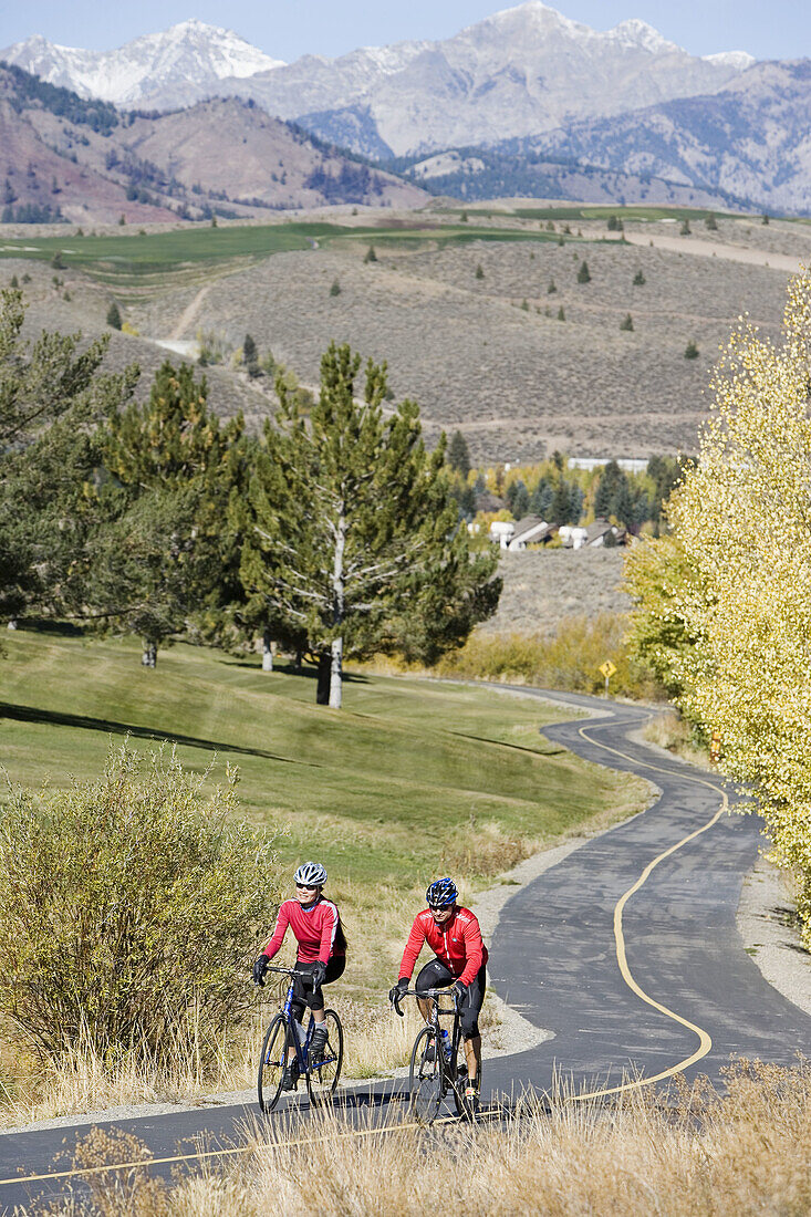 Couple road biking, Sun Valley, Idaho, USA