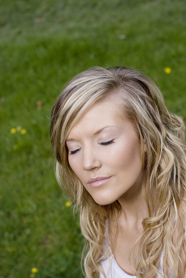 Beautiful young woman enjoying being outside in a green natural environment