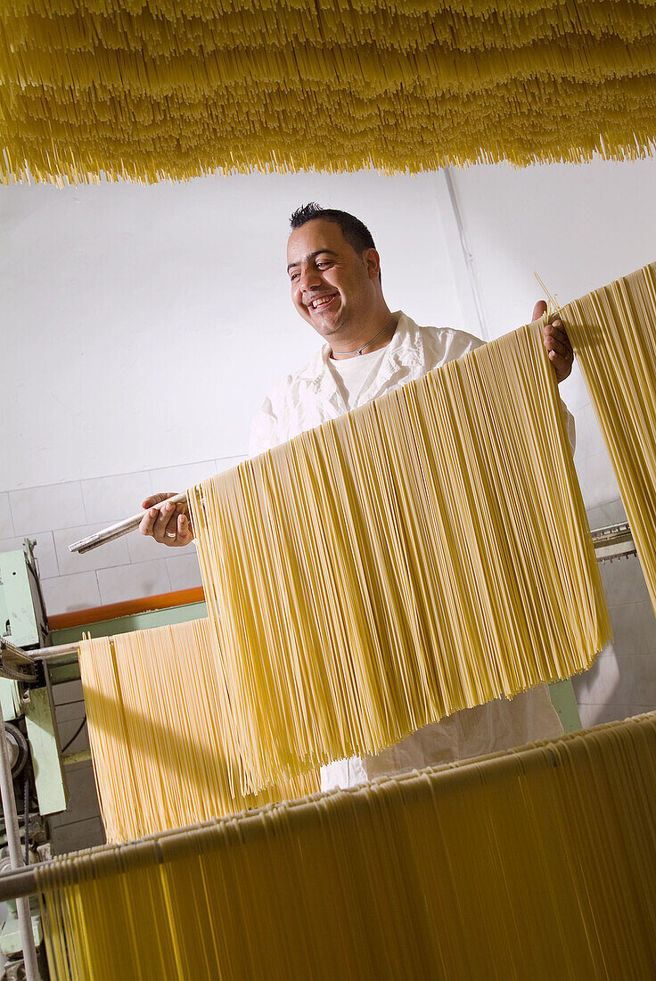 craftsman who prepares typical Italian spaghetti pasta