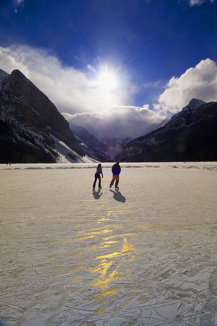 Ice skating on Lake Louise, near the Fairmont Chateau Lake Louise Hotel, Banff National Park, Alberta, Canada