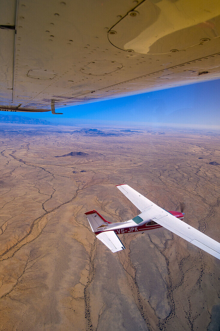 Two Desert Air Cessna 210s fly above the Namib Desert, Namibia