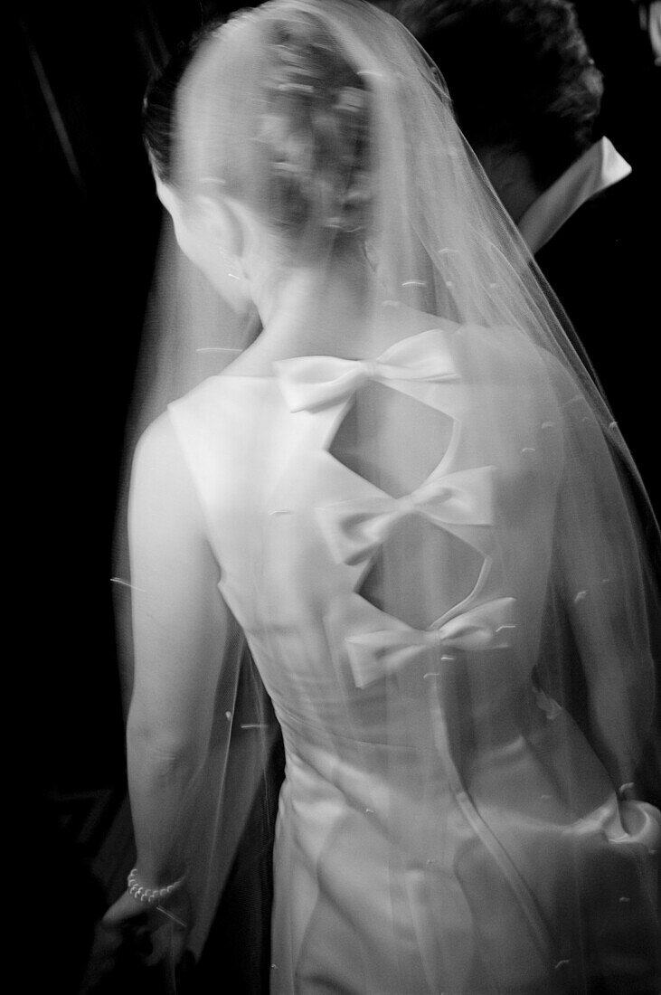 Adult, Adults, b&w, back view, black-and-white, blurred, Bow, Bows, bride, brides, Contemporary, Dress, Dressed up, Dresses, Elegance, Elegant, Female, human, indoor, indoors, interior, Knot, Knots, marriage, matrimony, Medium shot, Medium shots, One, One