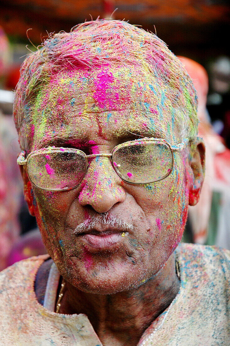 Panjim Goa, India, man with colored powder on the face during the Holi feast