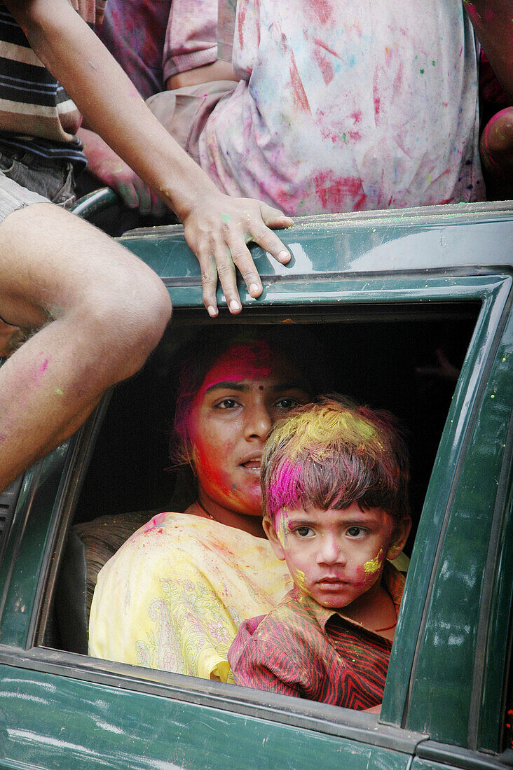 Panjim Goa, India, woman and child with colored powder on their faces during the Holi feast