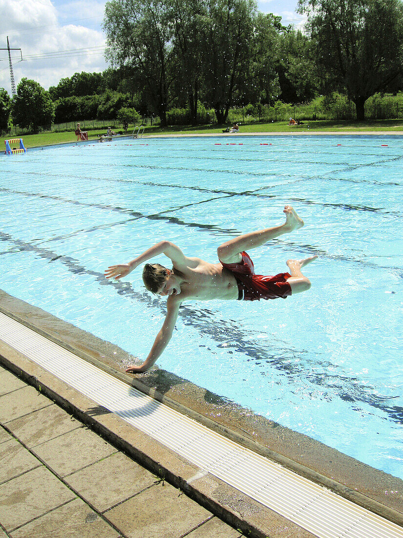 Boy jumping into the water.