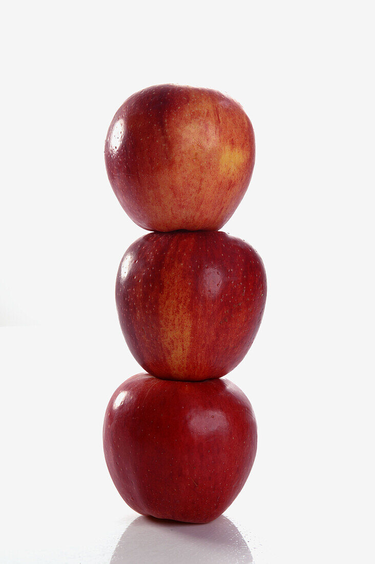 Three stacked red apples