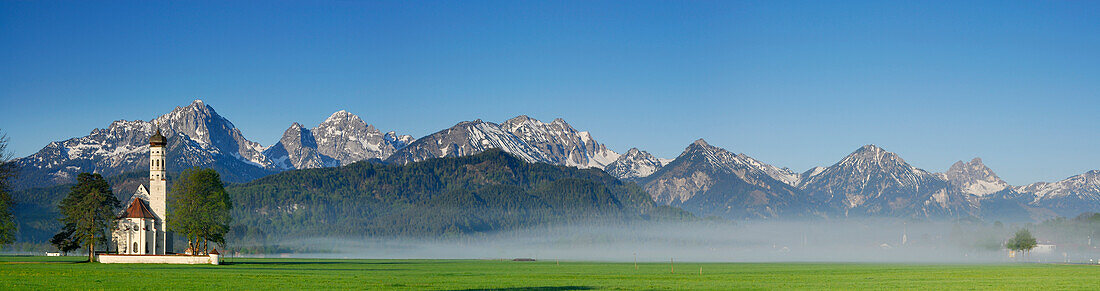 St. Coloman church in morning mist, near Schwangau, Allgaeu, Bavaria, Germany