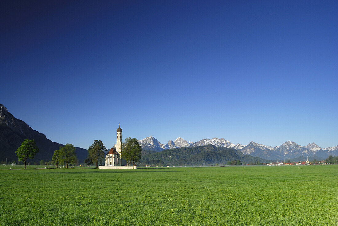 St. Coloman church with mountain range, near Schwangau, Allgaeu, Bavaria, Germany