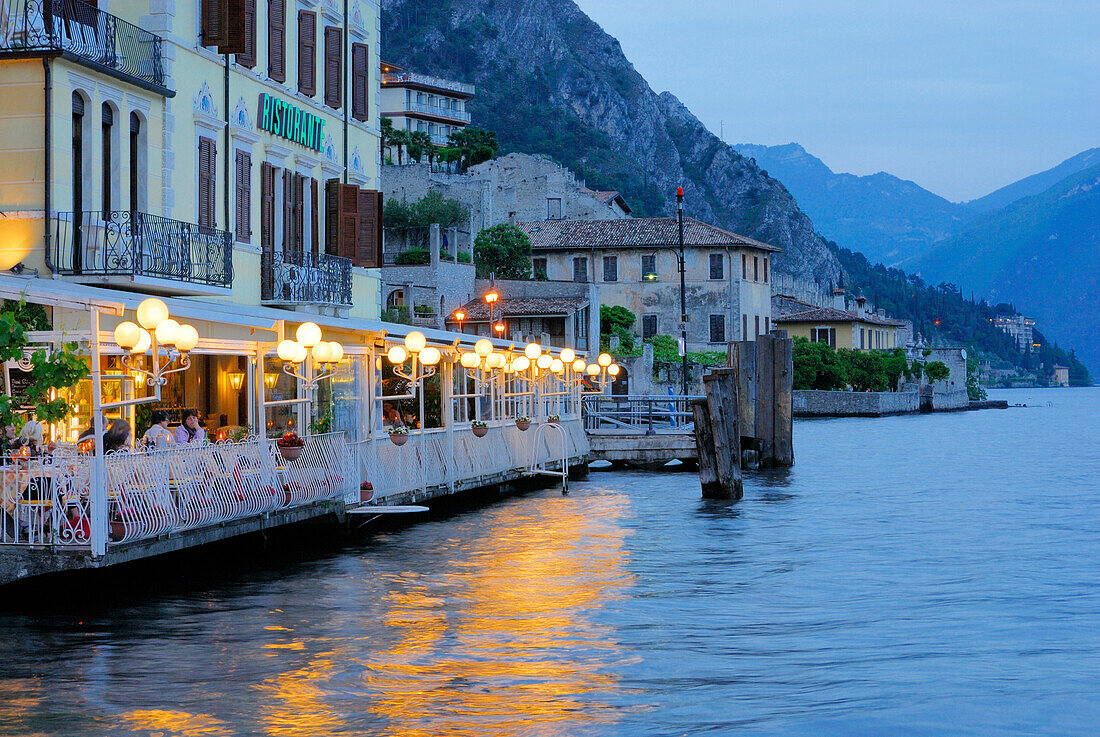 Illuminated terrace of a restaurant at lake Garda, Limone sul Garda, Lombardy, Italy