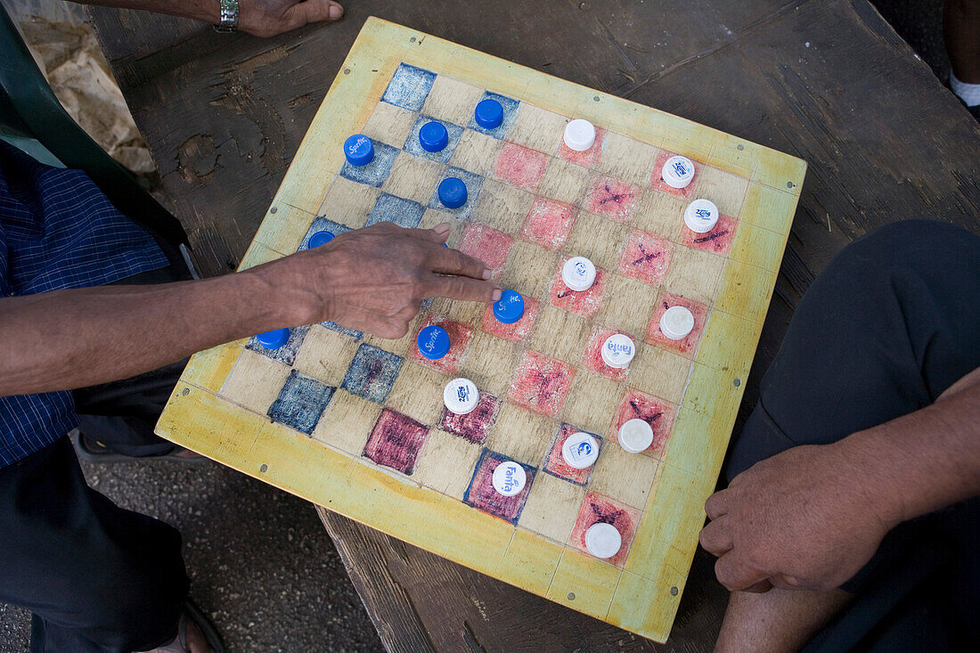 Locals playing checkers with bottle caps, Nuku'alofa, Tongatapu, Tonga, Oceania