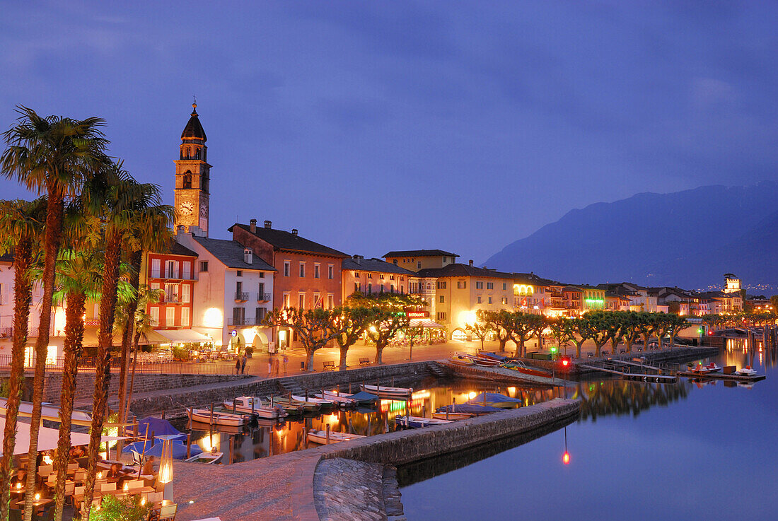 Church, harbour and illuminated seaside promenade in Ascona, Ascona, lake Maggiore, Lago Maggiore, Ticino, Switzerland