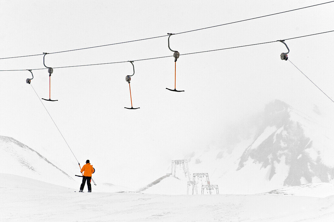 Skier using a drag lift, Hintertux, Tyrol, Austria