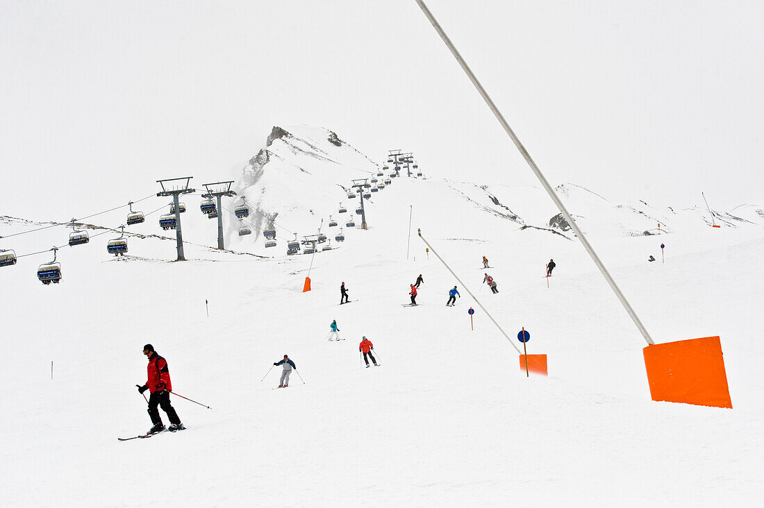 Skiers on slope, chairlift in background, Hintertux, Tyrol, Austria