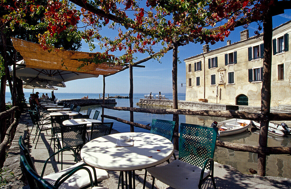 Tables of the restaurant Locando San Vigilio in the sunlight, Punta San Vigilio, Lake Garda, Veneto, Italy, Europe