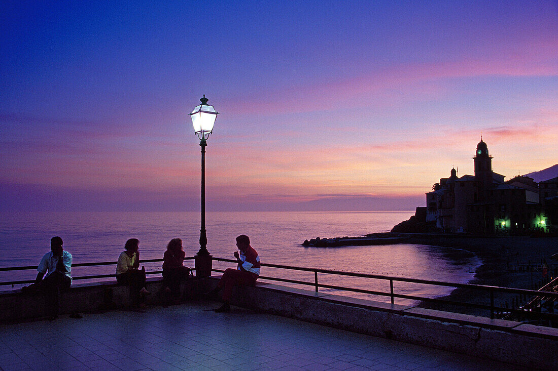 People sitting at a seaside terrace at dusk, Camogli, Liguria, Italian Riviera, Italy, Europe