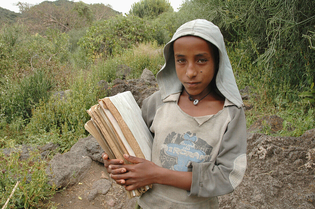 ETHIOPIA  Tullo Gudo island and its monastery of Debre Zion, Lake Ziway  Girl walking to school carrying her books