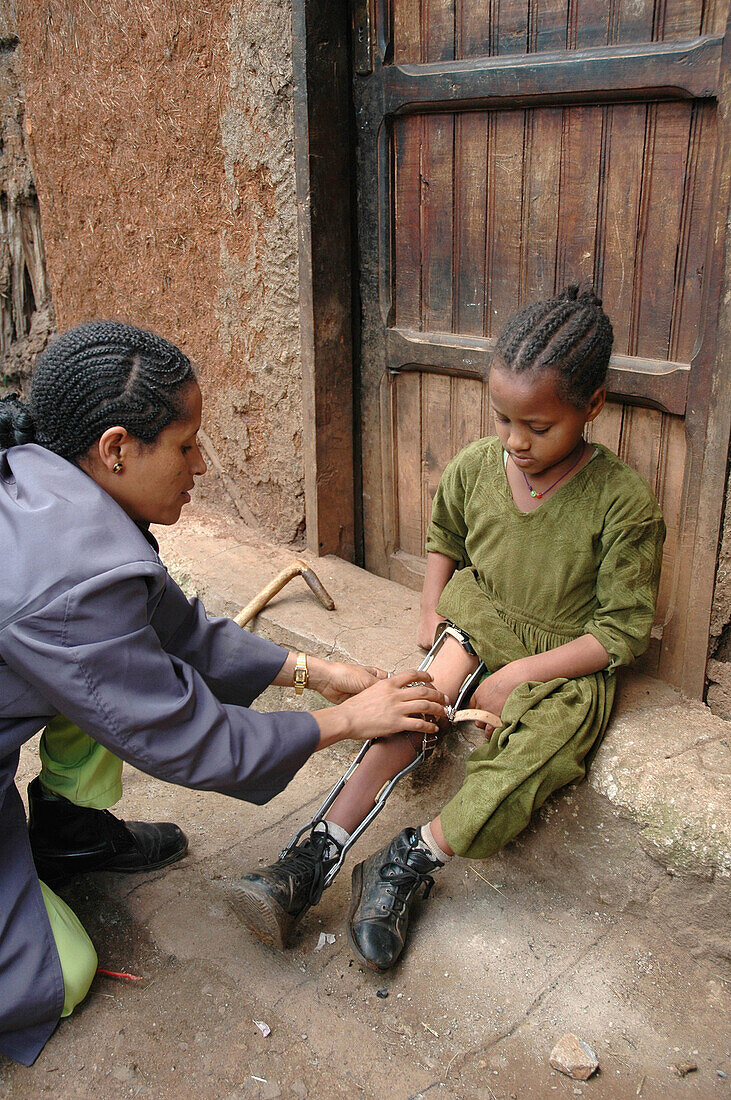 ETHIOPIA  Urban development project of the Daughters of Charity, Kabille 18, Addis Ababa  The project helps poor people with disabilities and health problems  Habtamu visiting Fekerte 8, polio victim, to check her irons