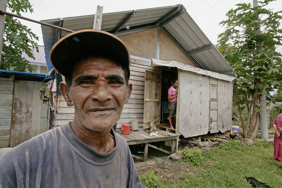 INDONESIA  Mohammed Sofyan Yusuf, a garbage recycler and CRS new house beneficiary, sorting recycables, Monikeun, a suburb of Banda Aceh, Aceh, two years after the Tsunami