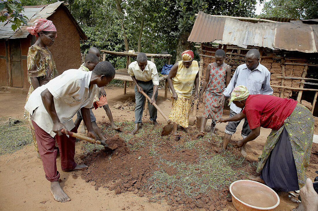 UGANDA  Making a mud, fuel-efficient wood burning cooking stove, Kayunga District