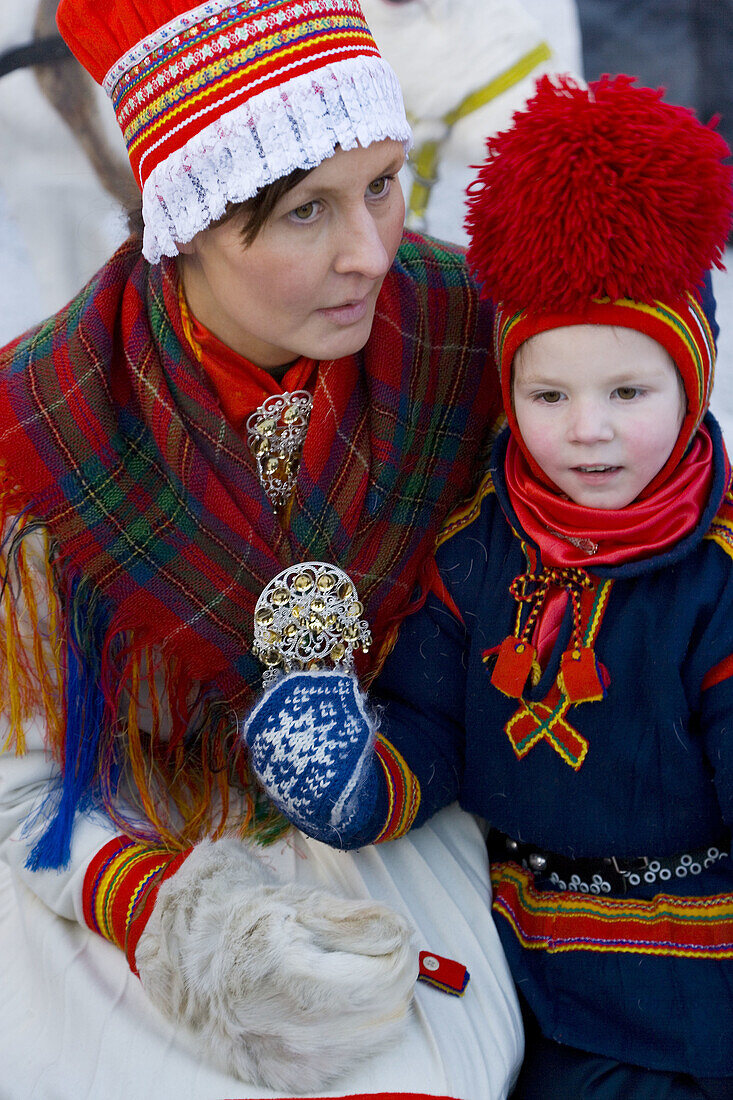 Sami (Lapp) boy with mother at Winter Fair. Jokkmokk, Northern Sweden