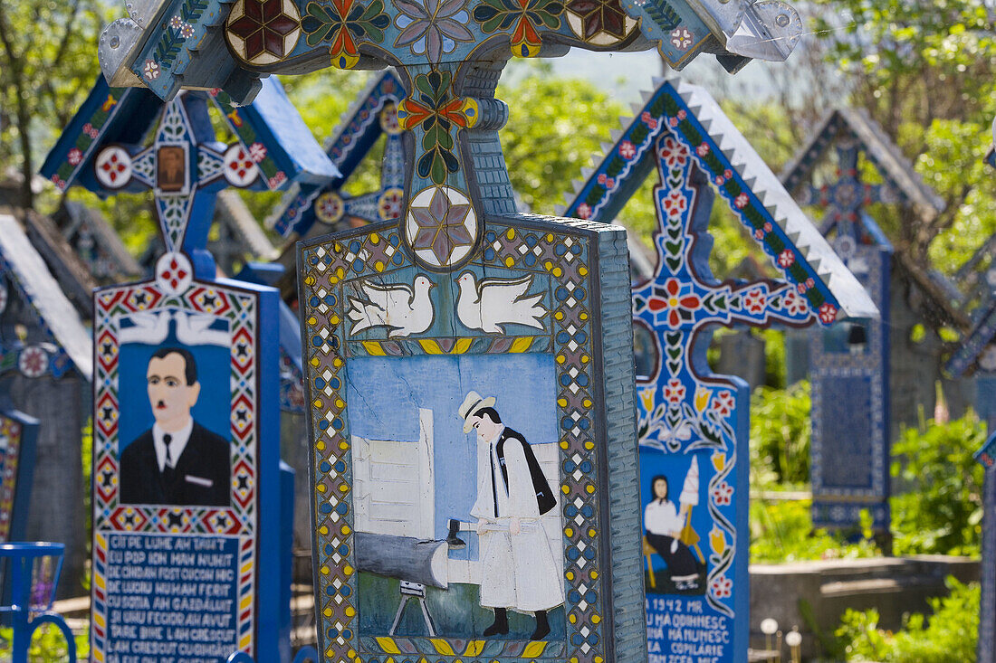 Merry Cemetry each cross has a colourful depection of the desceased life, Sapanta, Maramures, Romania