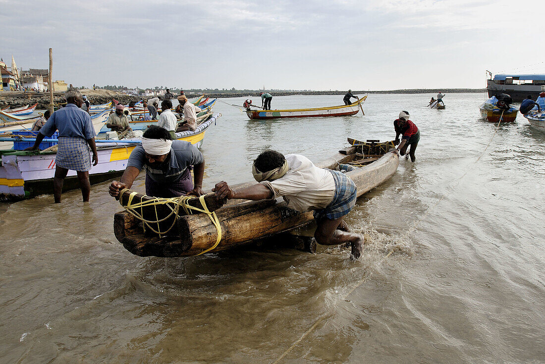 Fishermen pushing the Catamaran ashore after the catch, Kanyakumari, India