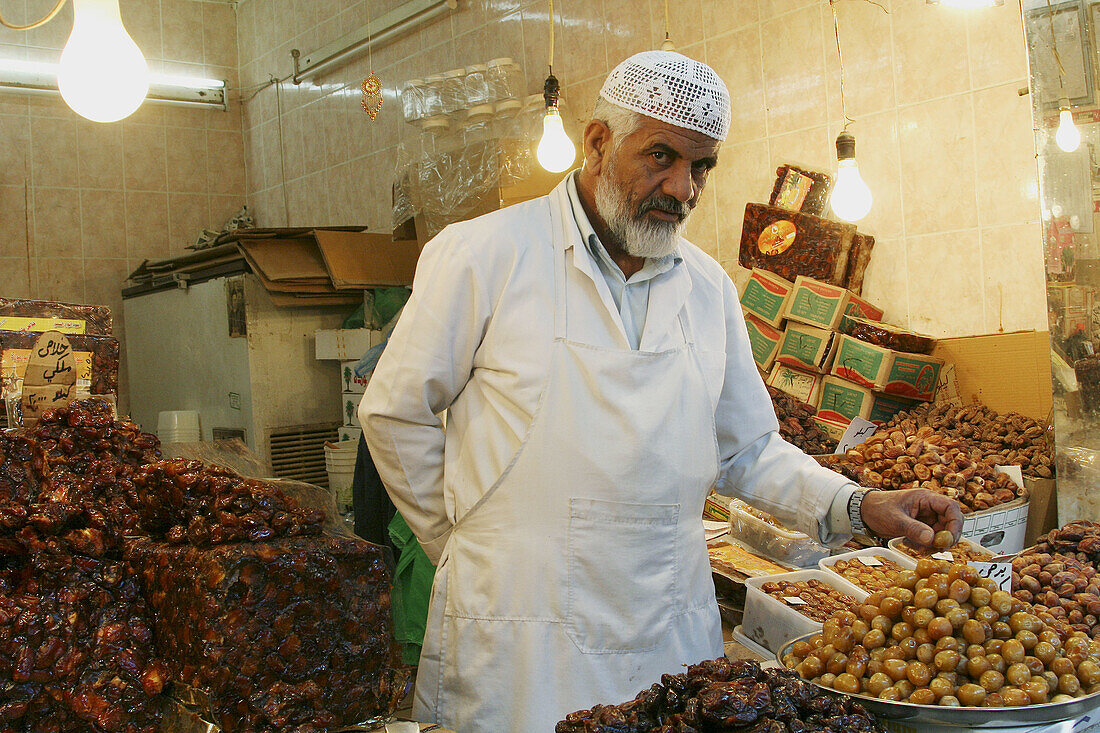 Parisian man sales date in shop at old market Al Mubarkia Souk, Kuwait City, Kuwait