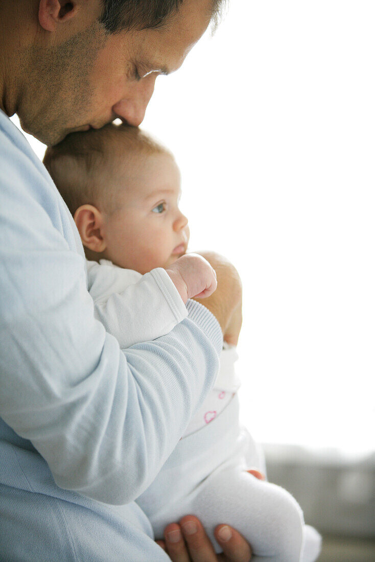 Father holding baby girl (8 month), Vienna, Austria
