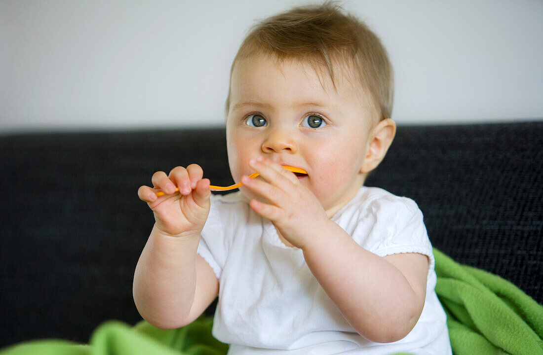 Baby girl (8 month) with a spoon, Vienna, Austria