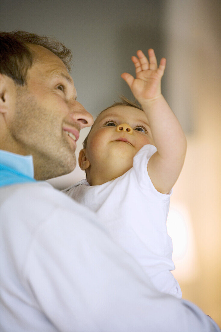 Father holding baby girl (8 month), Vienna, Austria