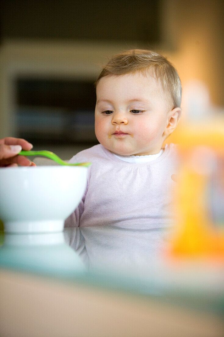 Baby girl (8 month) eating, Vienna, Austria
