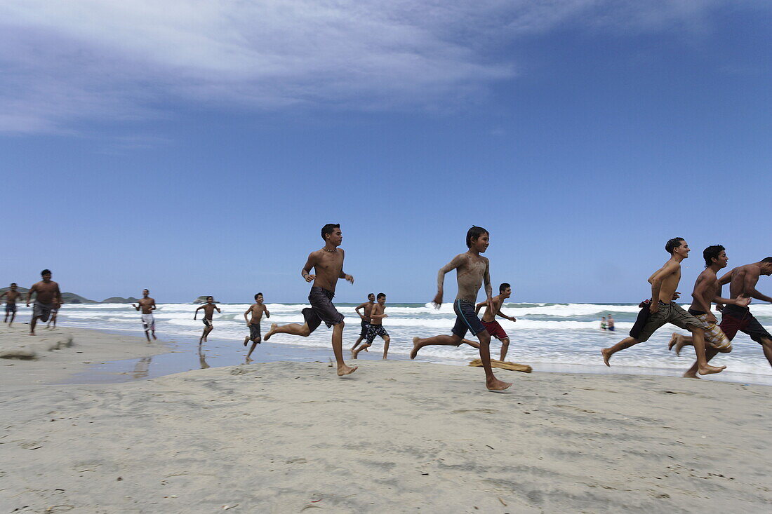 Junge Leute rennen am Strand entlang, Playa El Aqua, Isla Margarita, Nueva Esparta, Venezuela