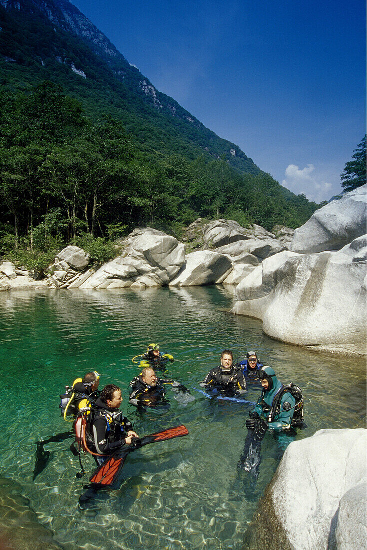 Divers in a lake at Valle Verzasca, Ticino, Switzerland, Europe