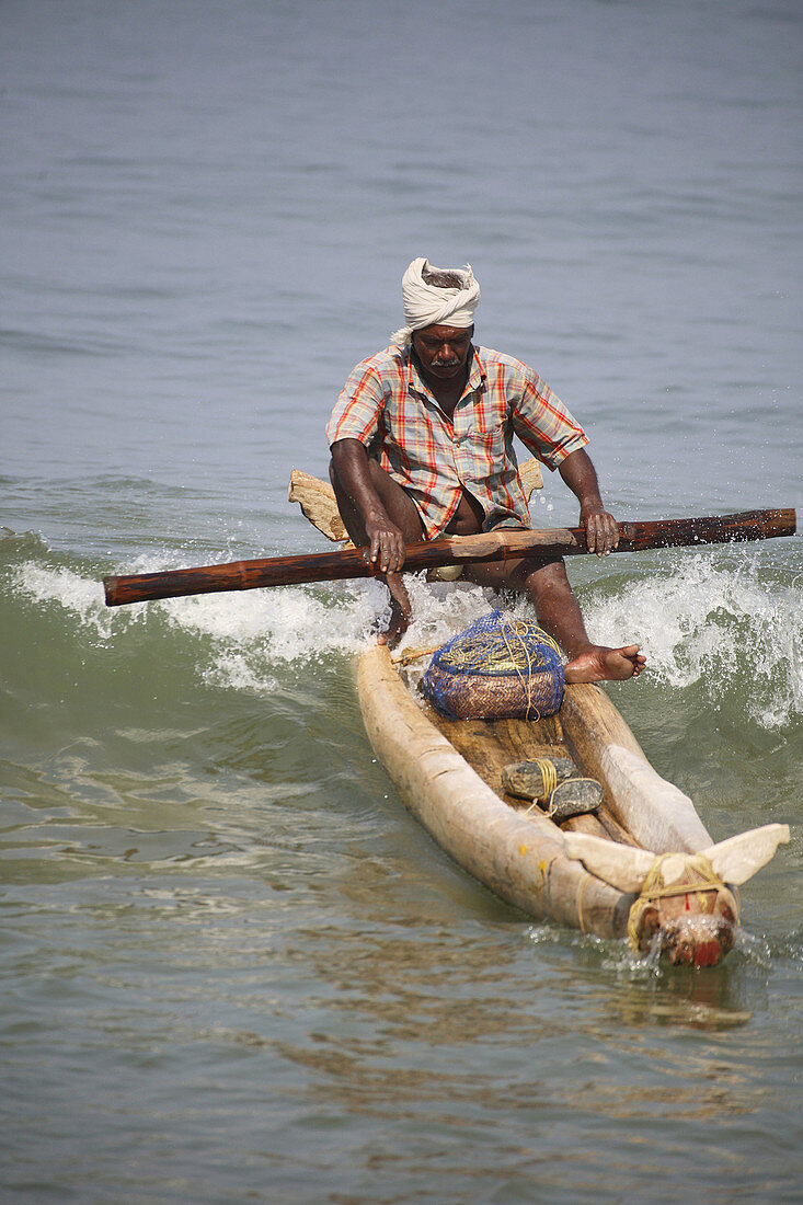 Fisherman in canoe, Kovalam, Kerala, India