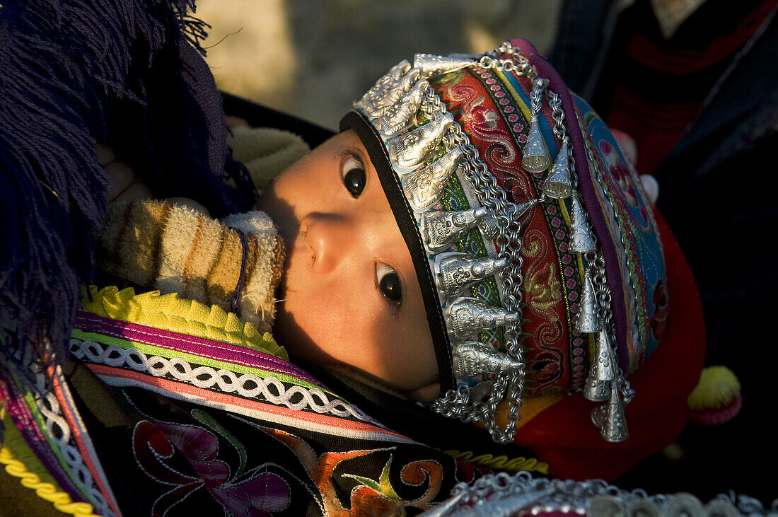 A cute Hani girl dressed in a traditional dress, China