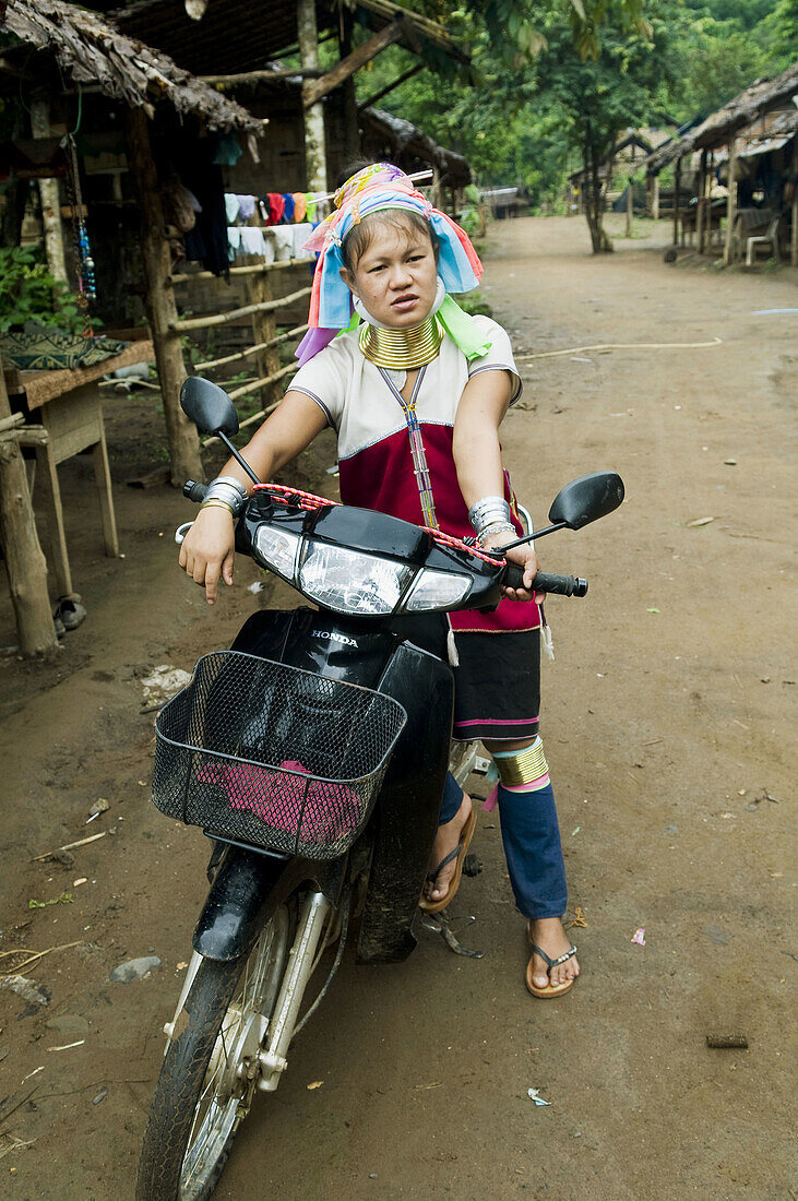 A Padong woman on her scooter