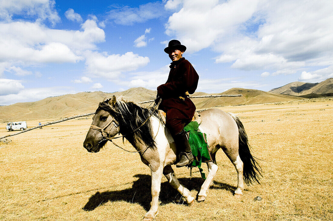 Most Mongolians live in the vast grasslands raising cattle and horses  they roam the land on their horses