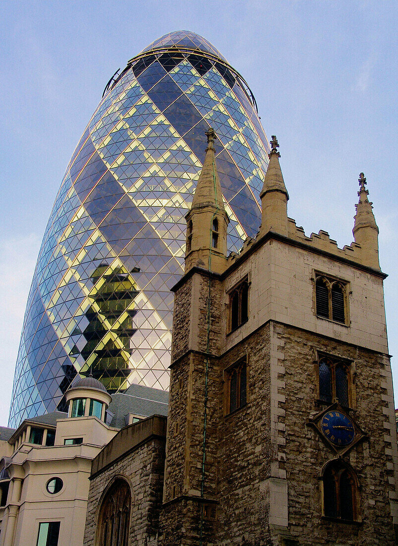 Swiss Re tower and St Andrew Undershaft church, London. England, UK