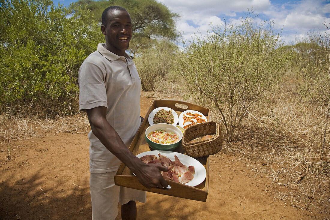 Man presenting lunch in the Tarangire Safari Camp, Tanzania