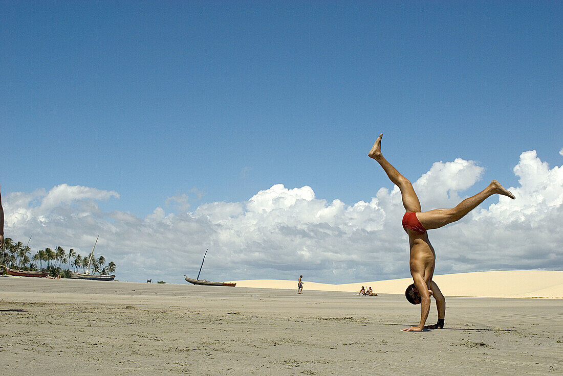 Capoeira player training  in the beach, Jericoacora, Brazil.