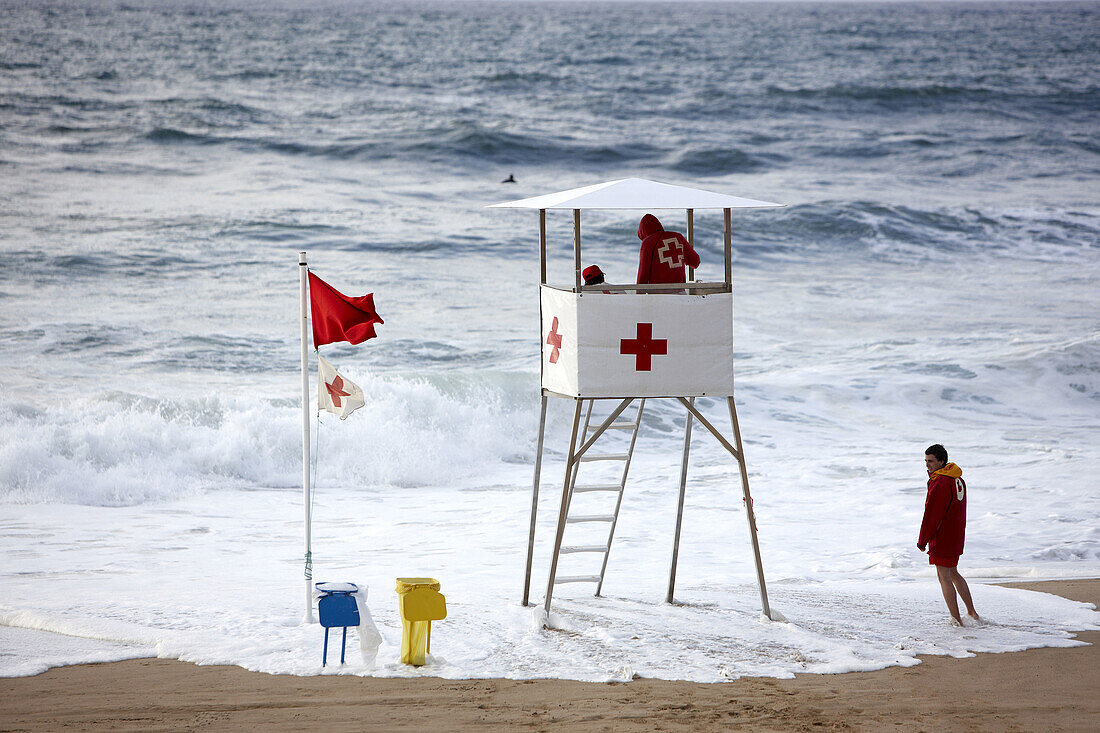 Red Cross lifeguard chair on Zurriola beach, San Sebastian. Guipuzcoa, Basque Country, Spain