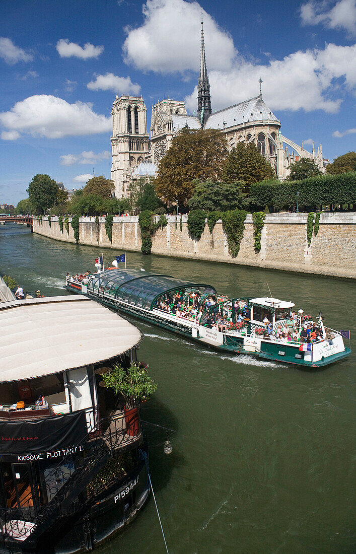 Tourist boat and Notre Dame cathedral. Paris. France.