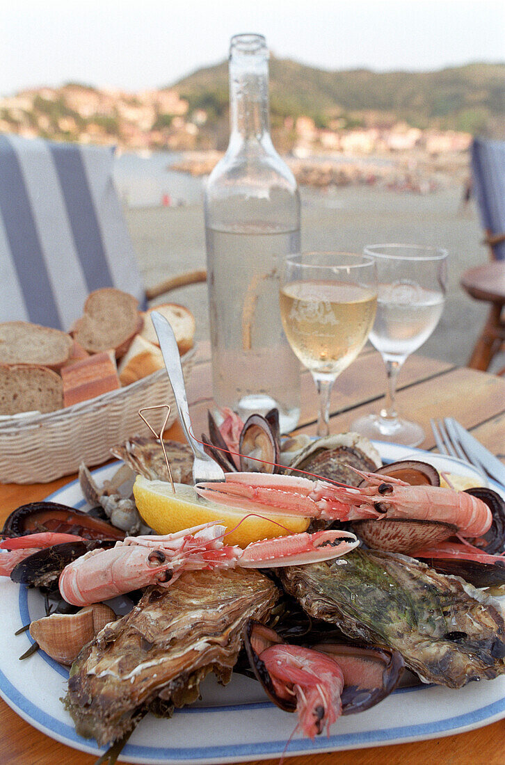 Plate with seafood, lunch in a restaurant near the beach, Collioure harbour, Languedoc-Roussillon, South France, France