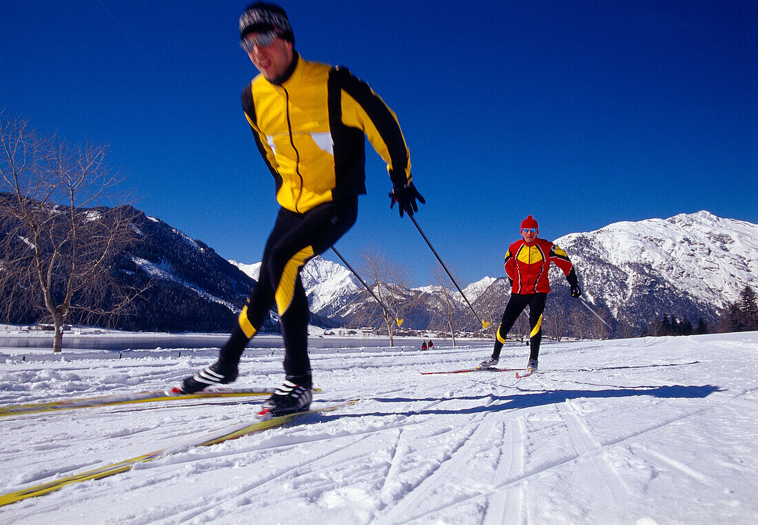 Two men cross-country skiing under blue sky, Tyrol, Austria, Europe