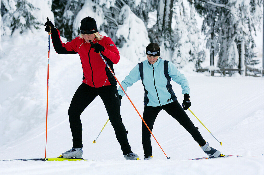 Two young women cross-country skiing, Tyrol, Austria, Europe